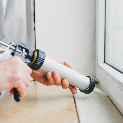 sealing window with caulk to prevent bugs from entering